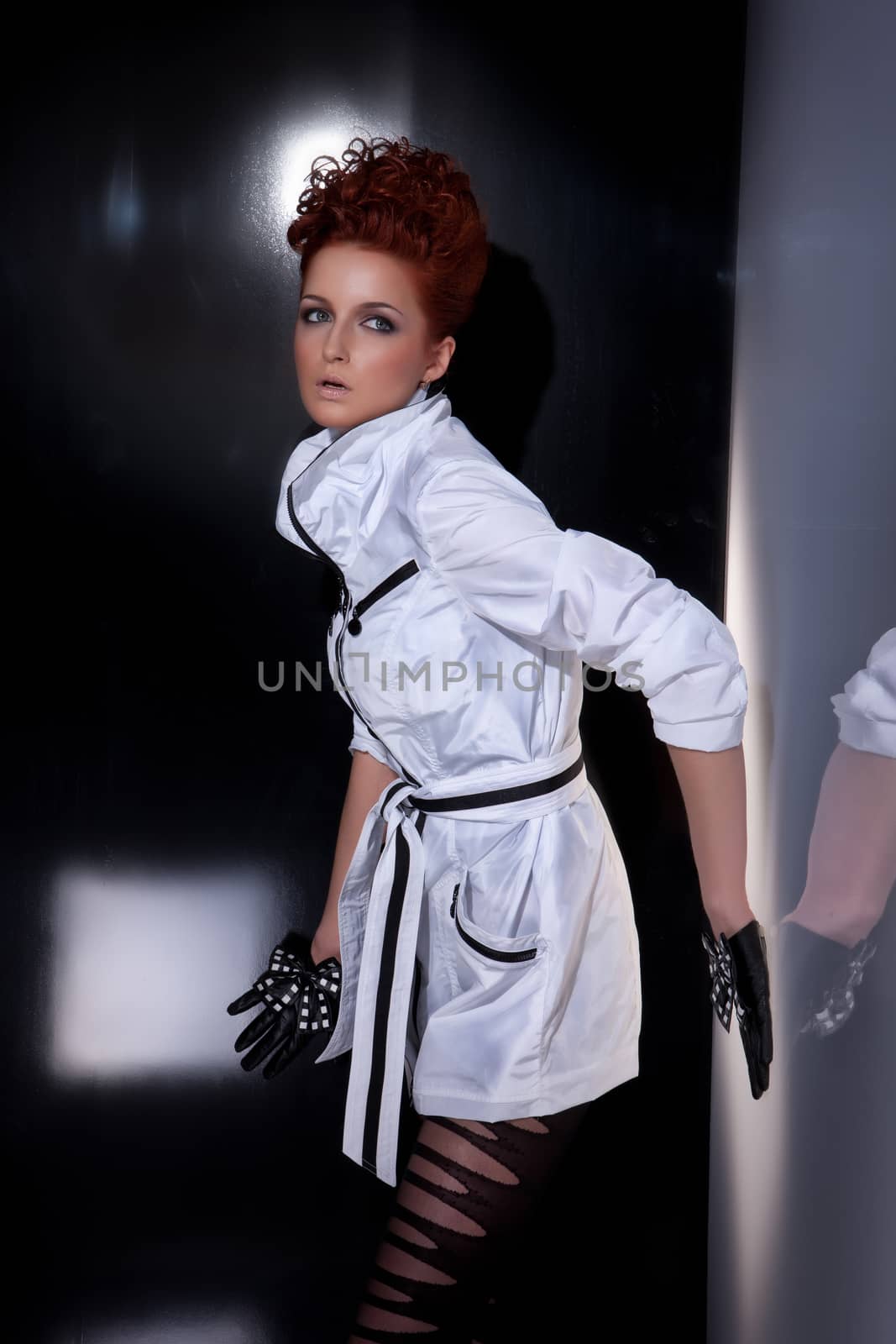 Young beautiful woman in fashionable clothing on isolated studio background