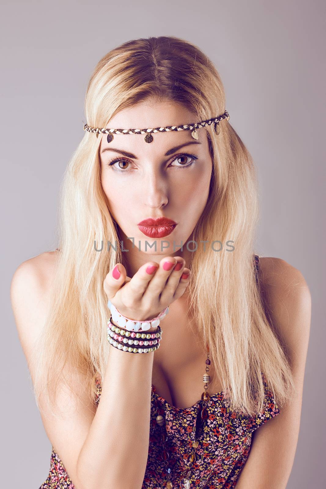 Hippie boho woman sending kiss. Beauty sexy playful positive blonde, long hair, ethnic accessories. Floral sundress, romantic style. Attractive loving girl, portrait.Unusual creative, people,copyspace