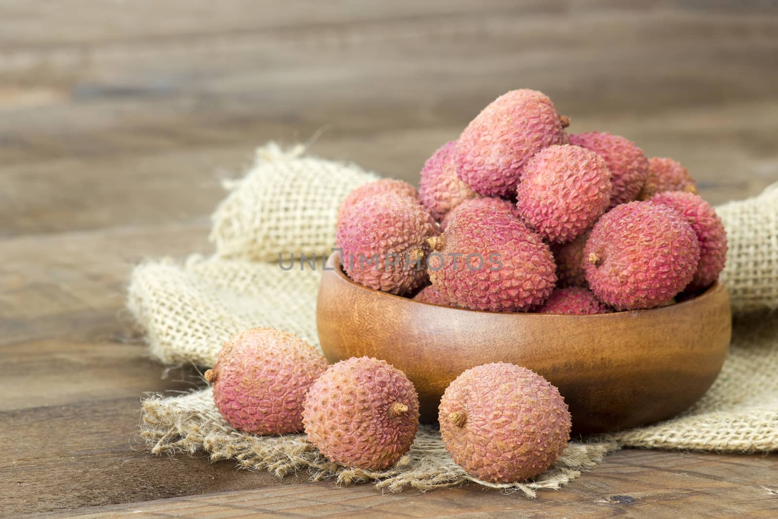 fresh lychees in a bowl  on wooden background