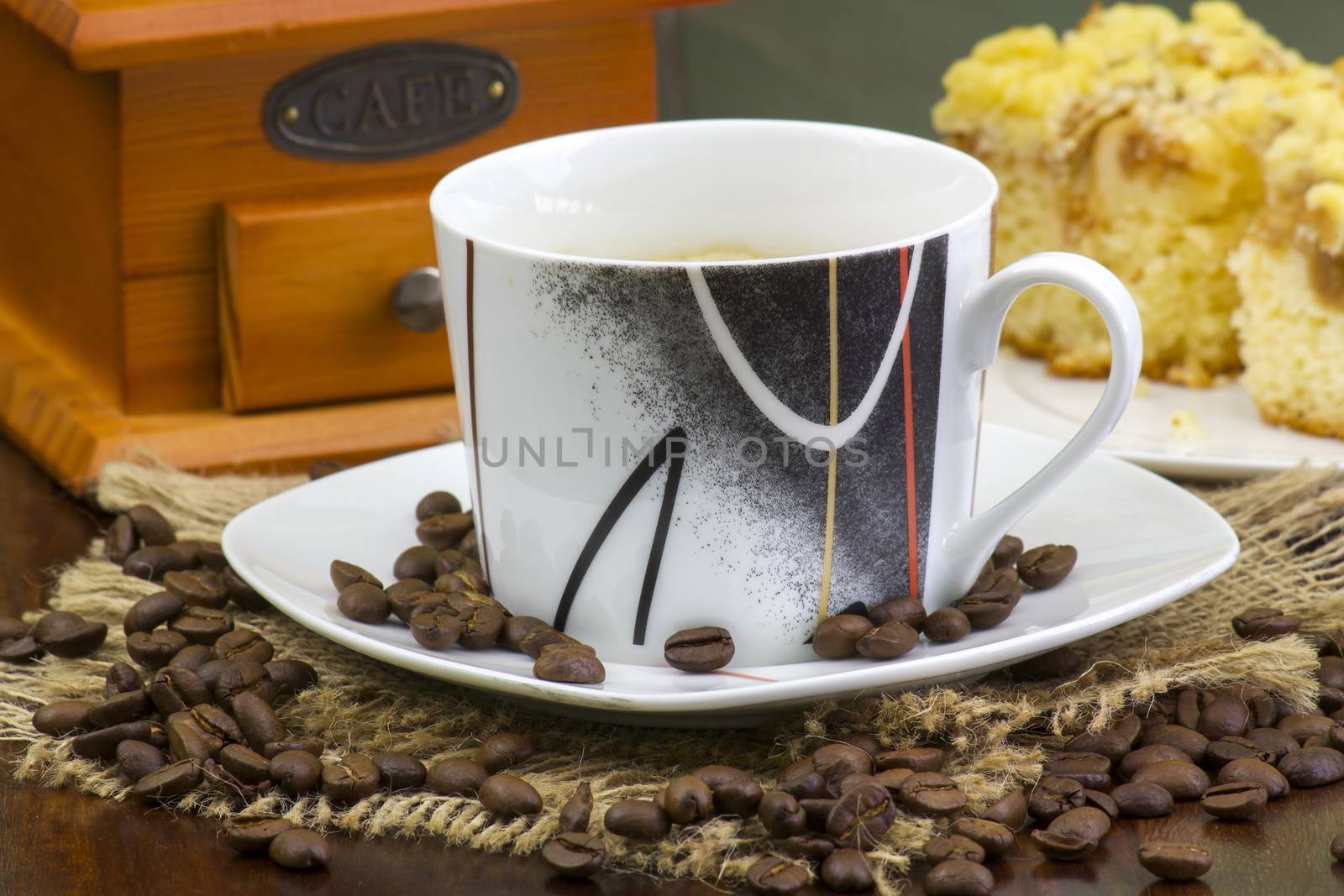 cup of coffee, apple cake and coffee grinder on wooden background