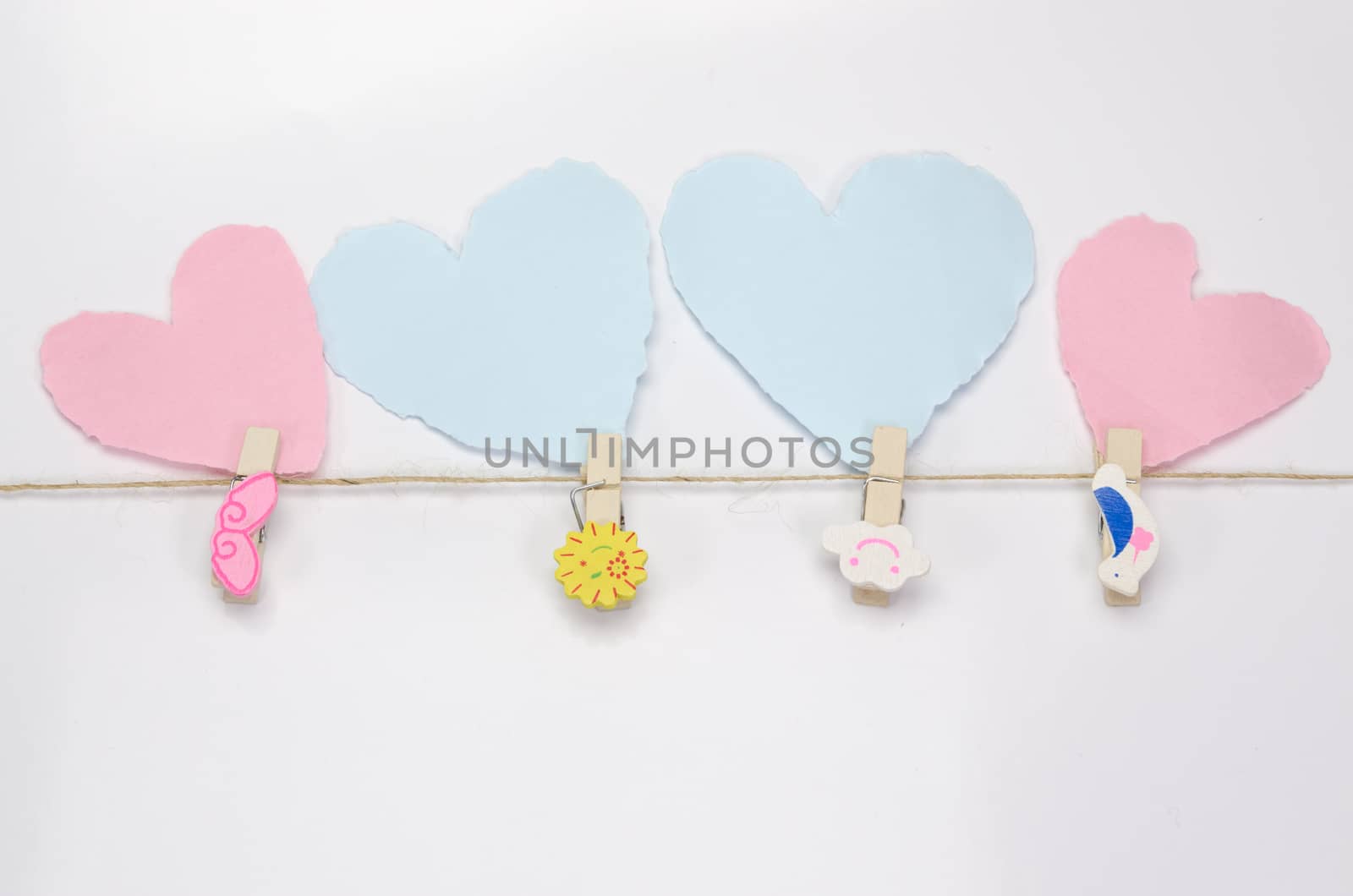 Beautiful paper hearts connected with a rope on white paper background