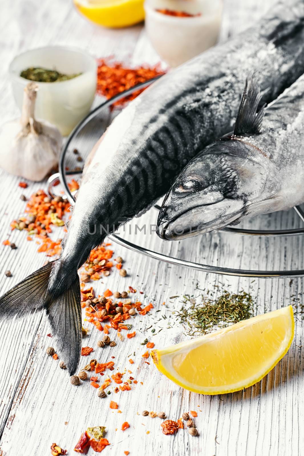 Thawed fresh fish mackerel with spices and marinade with lemon