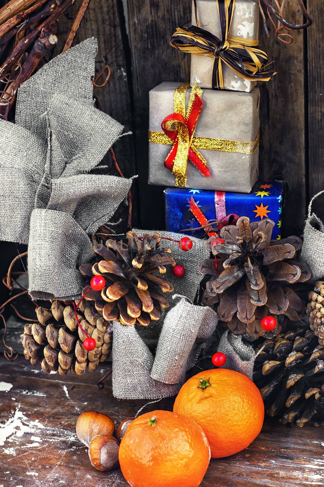 Winter composition with tangerines,pine cones and gifts