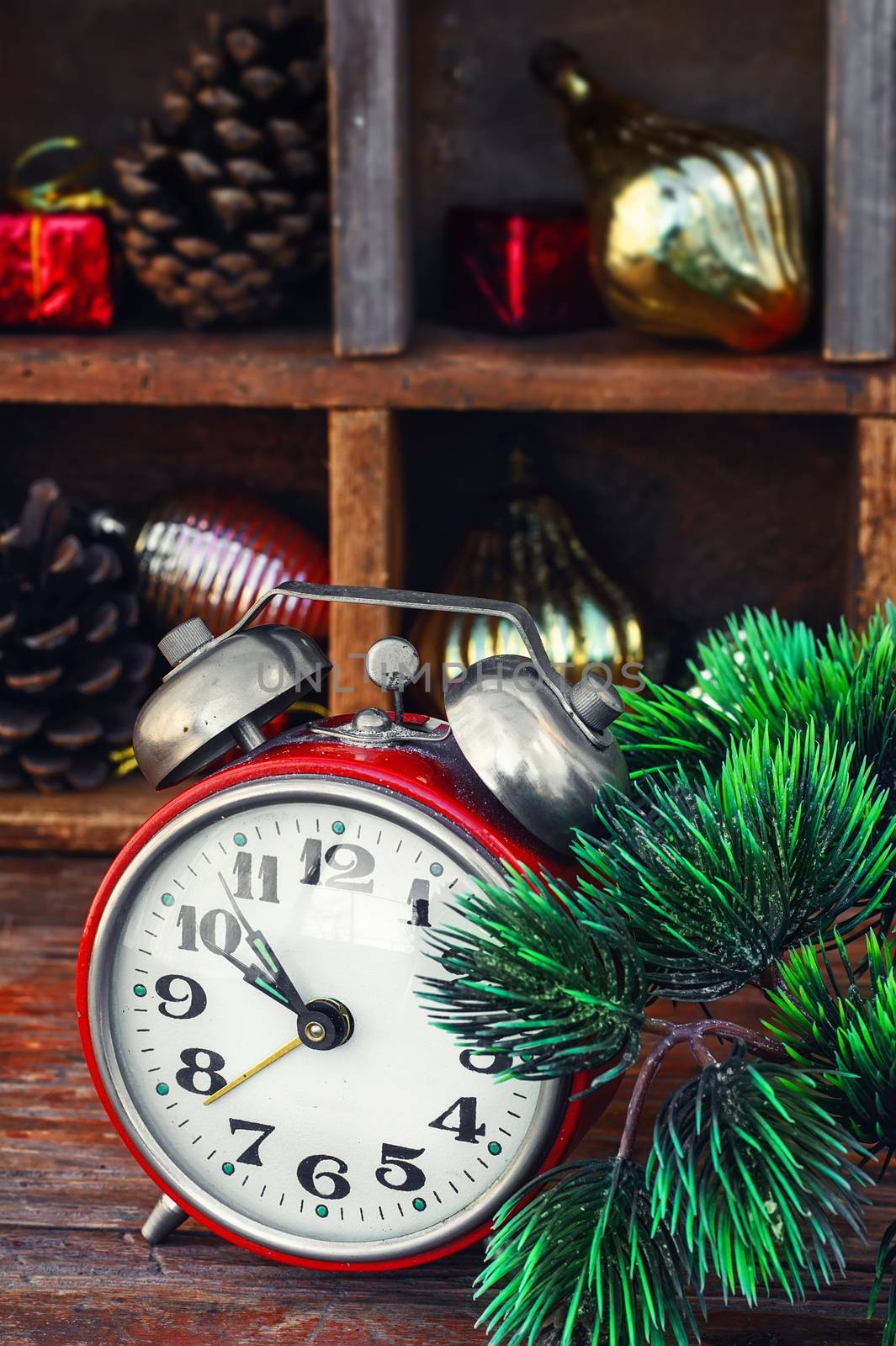 Clock alarm clock with bells on the background of Christmas decorations