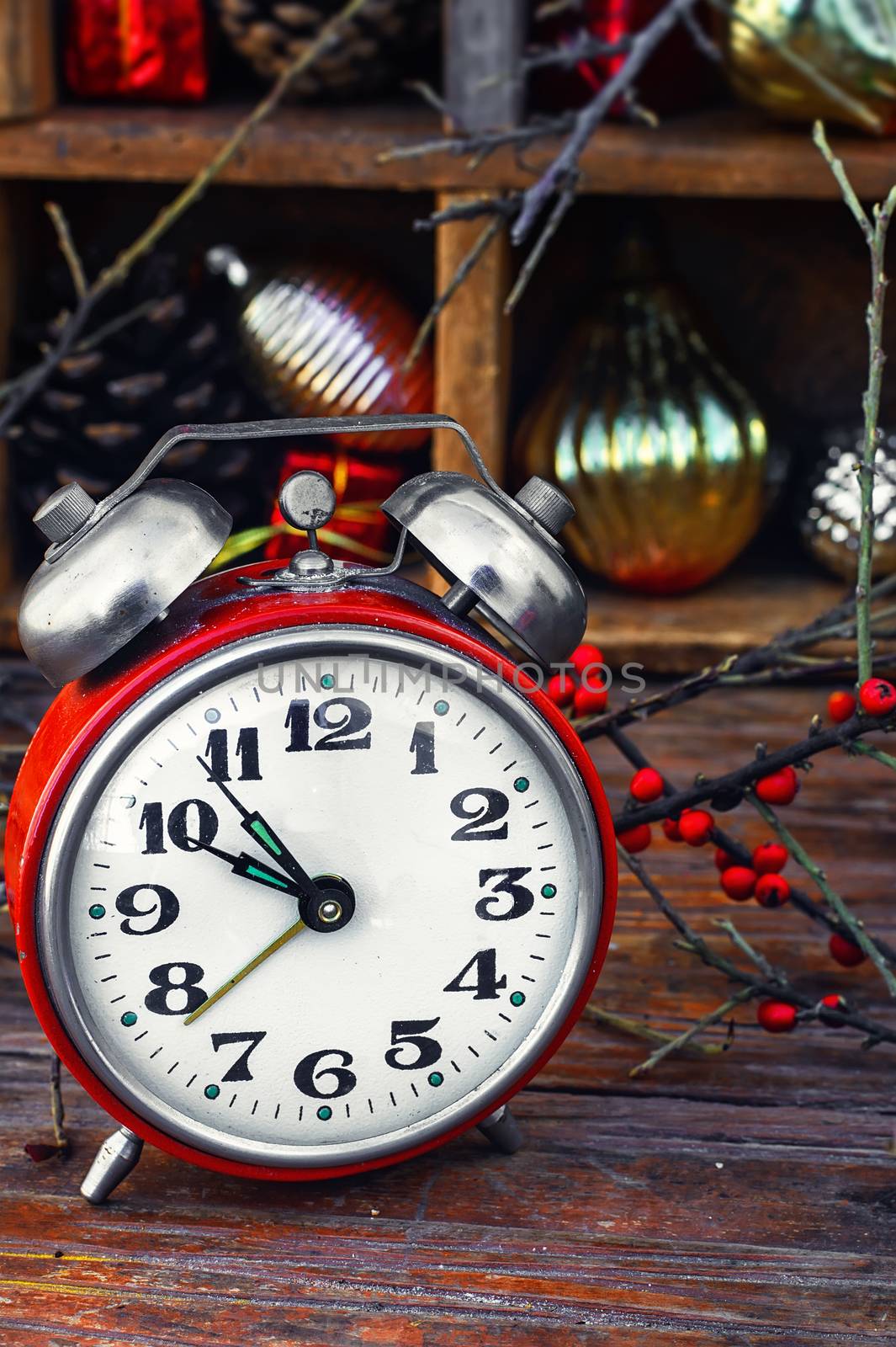 Clock alarm clock with bells on the background of Christmas decorations