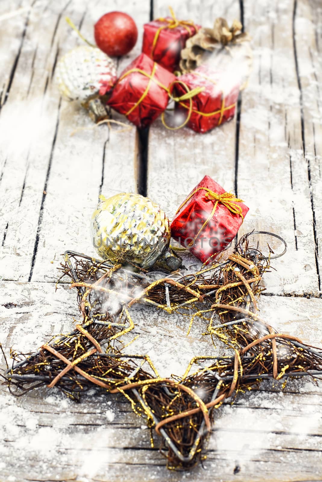 Woven wire Christmas star on wooden background with snow