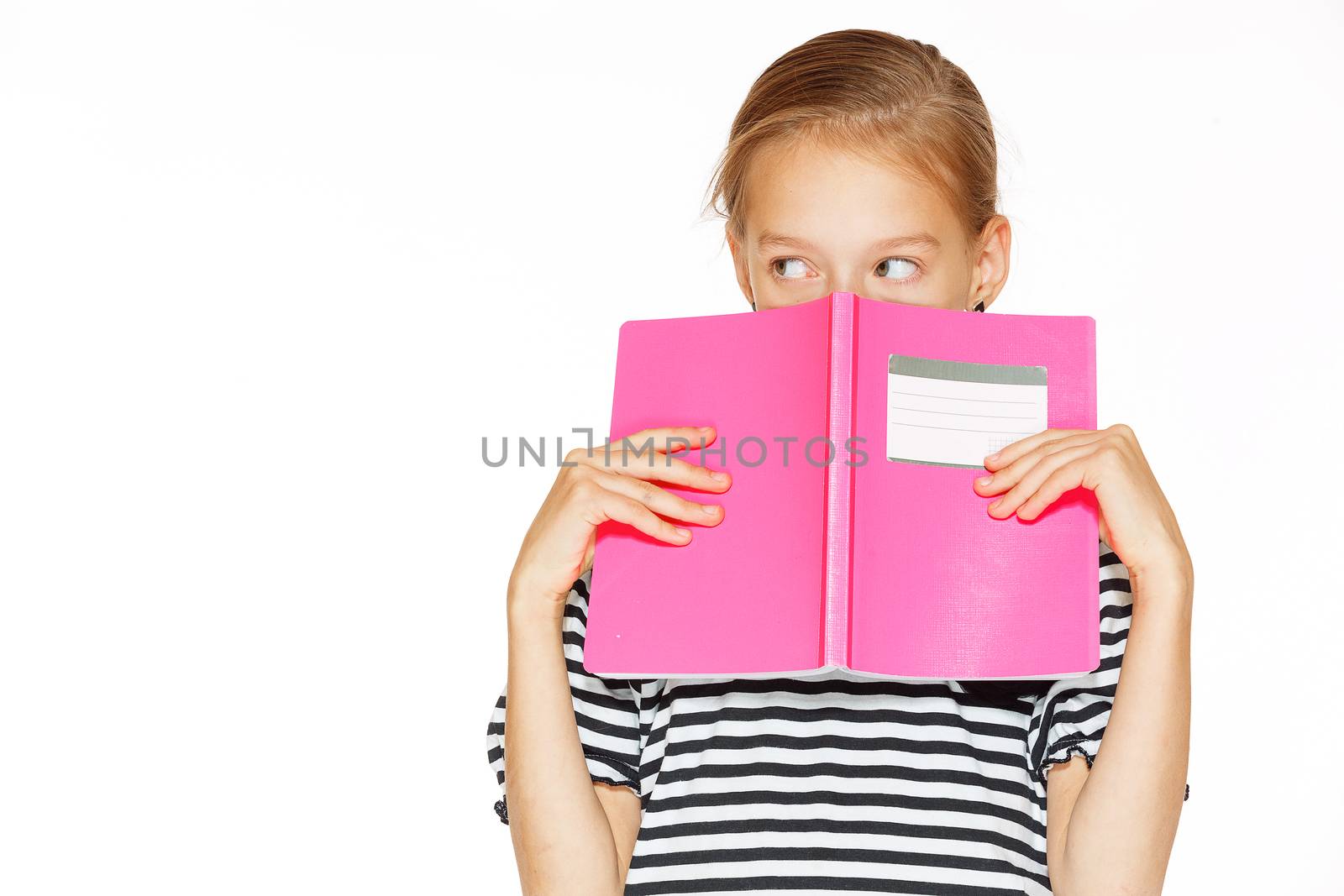 Beautiful little girl in blue dress with copybook. Isolated on white.