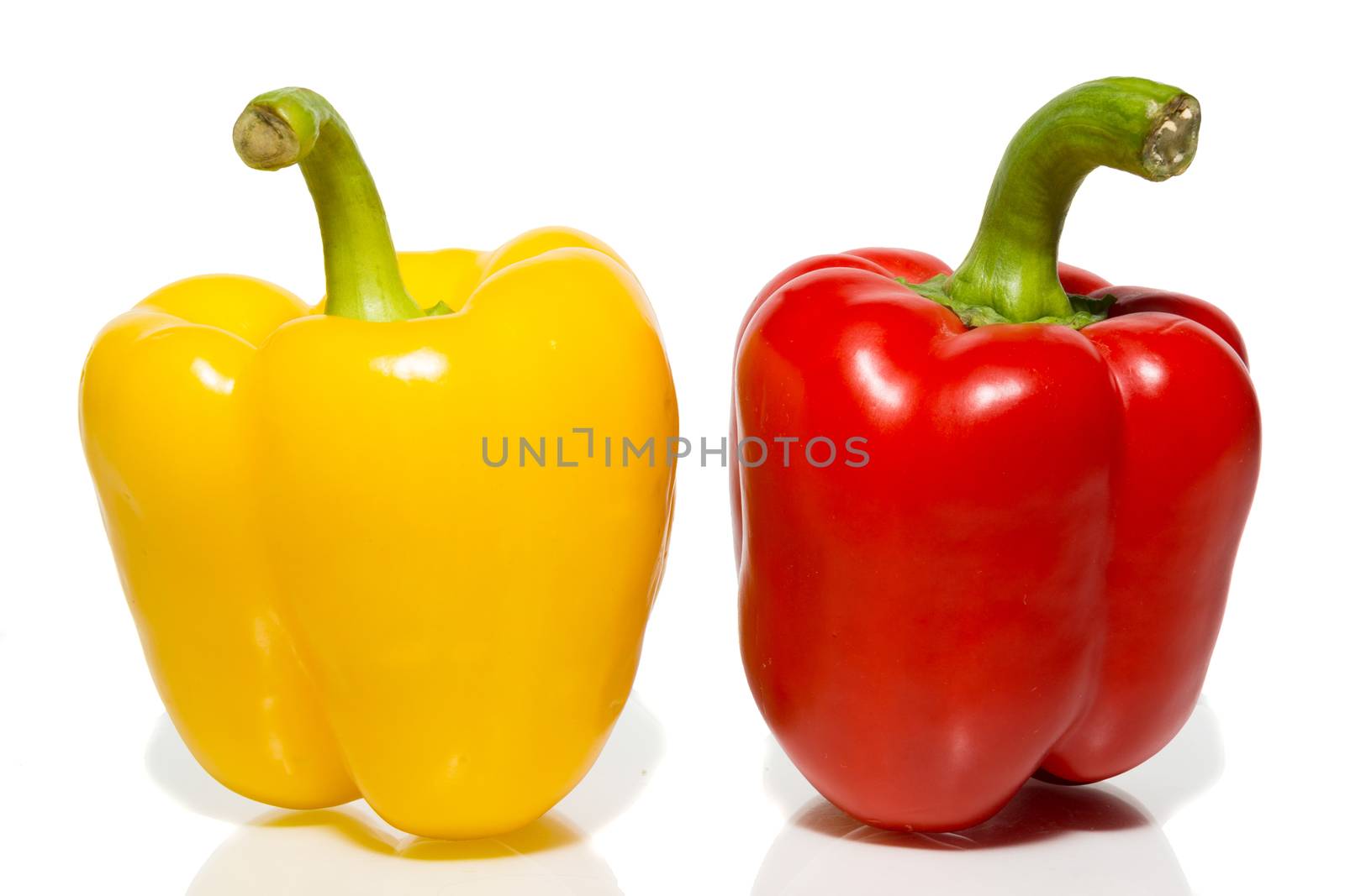The photograph depicts peppers on a white background