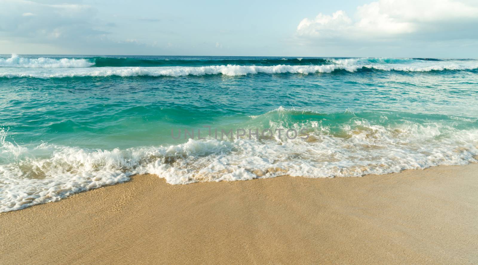 The sea rushes up meeting the sand on Oahu Island in the Pacific Ocean of North America