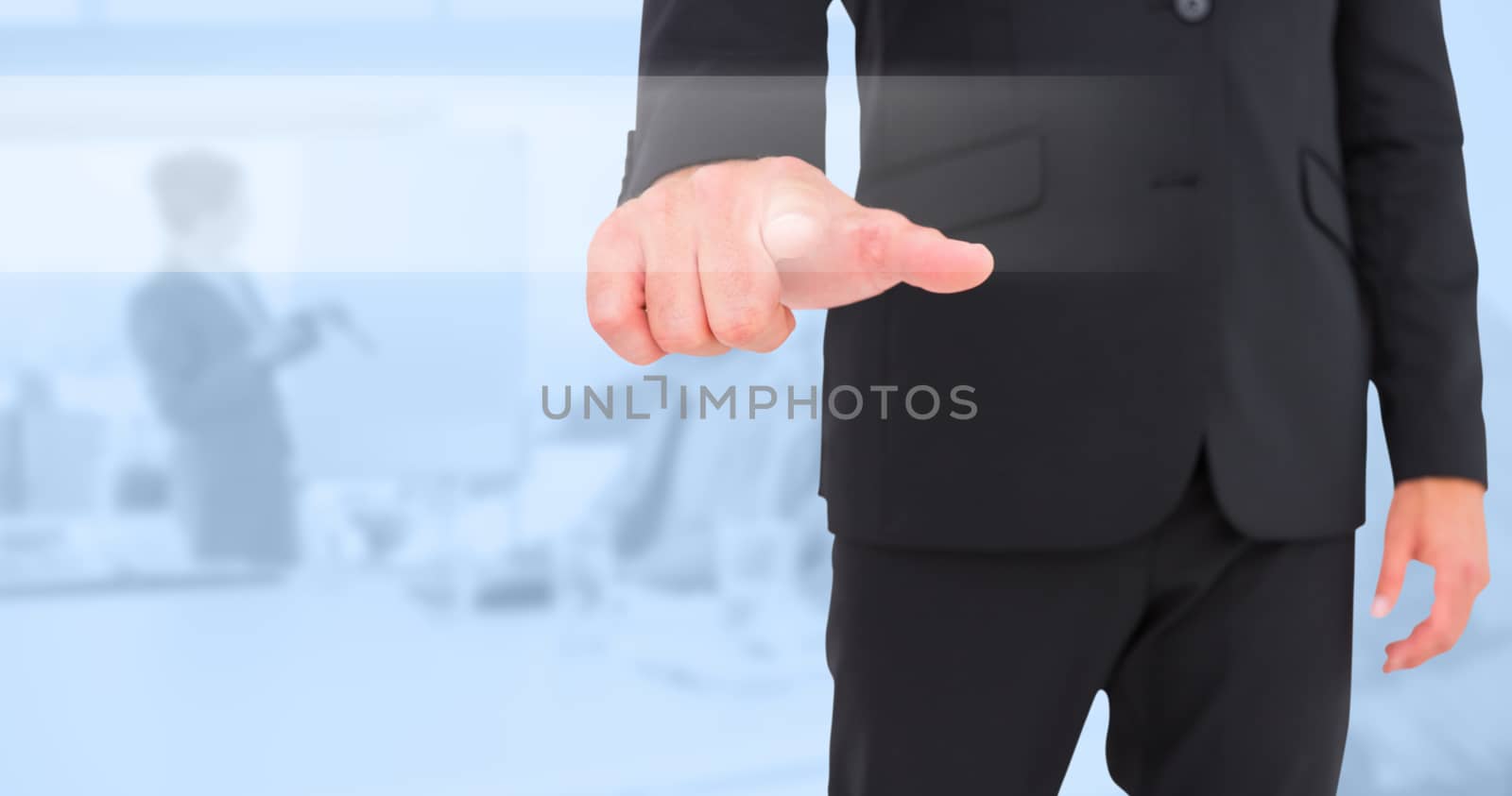 Businessman pointing with finger against blue background