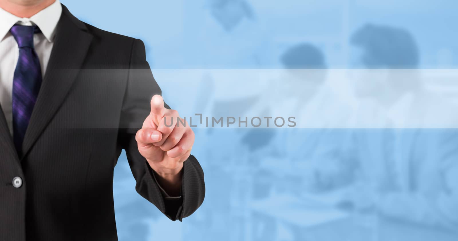 Businessman standing and pointing against blue background