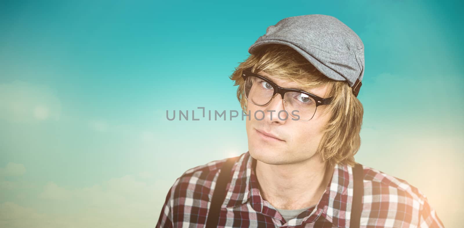 Composite image of serious blond hipster staring by Wavebreakmedia