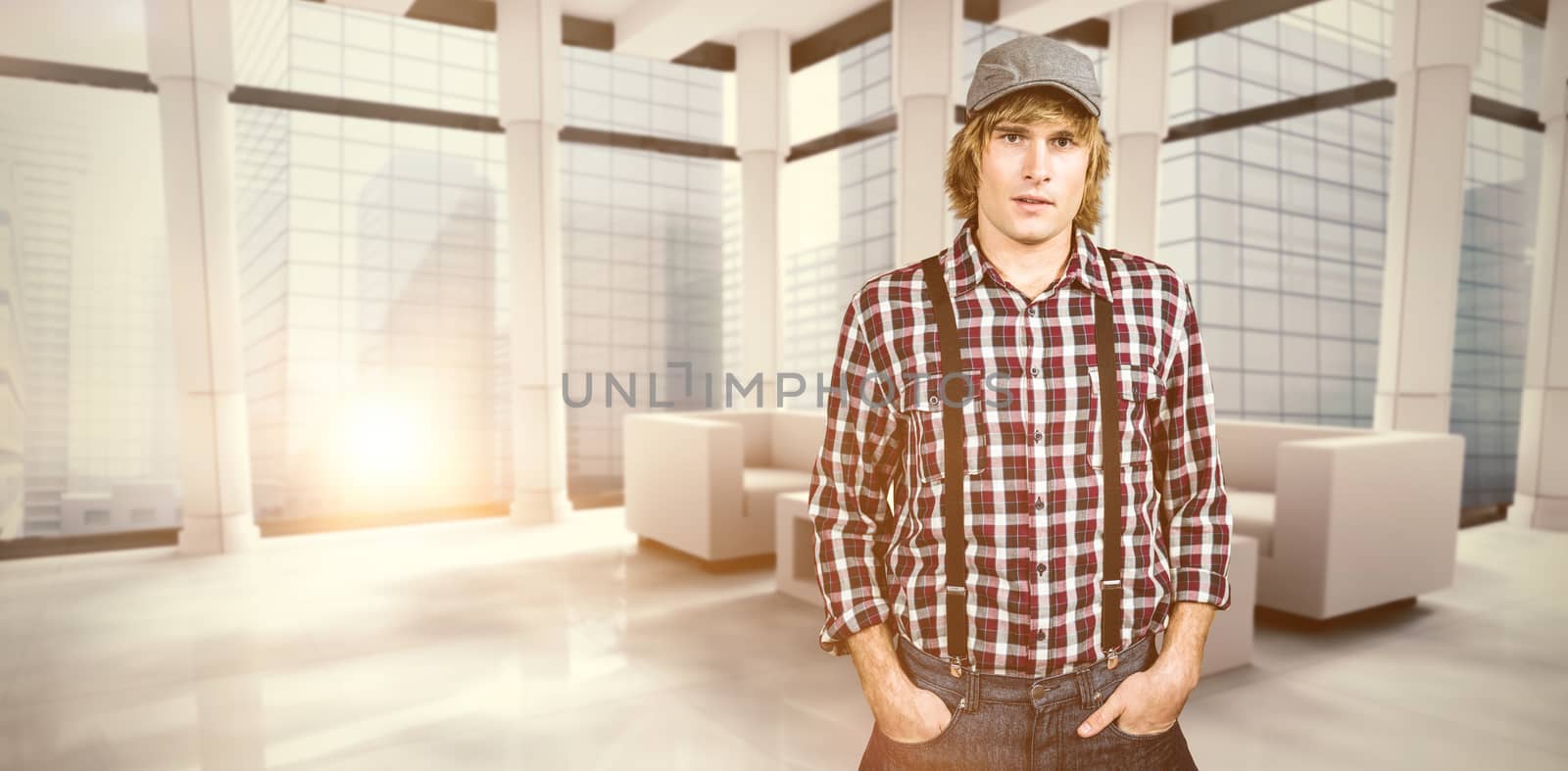 Serious blond hipster staring at camera against modern room overlooking city
