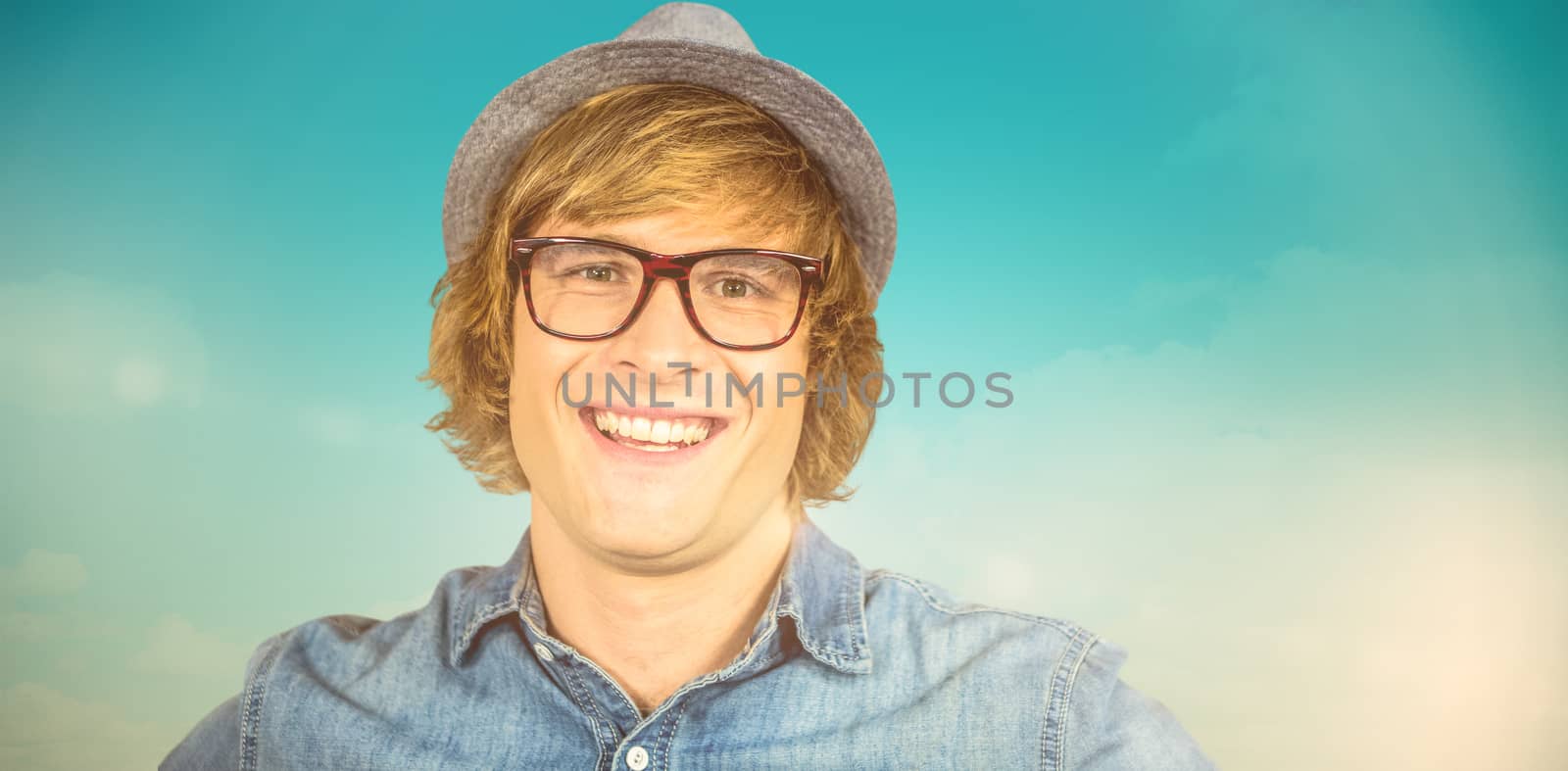 Composite image of smiling blond hipster staring at camera by Wavebreakmedia