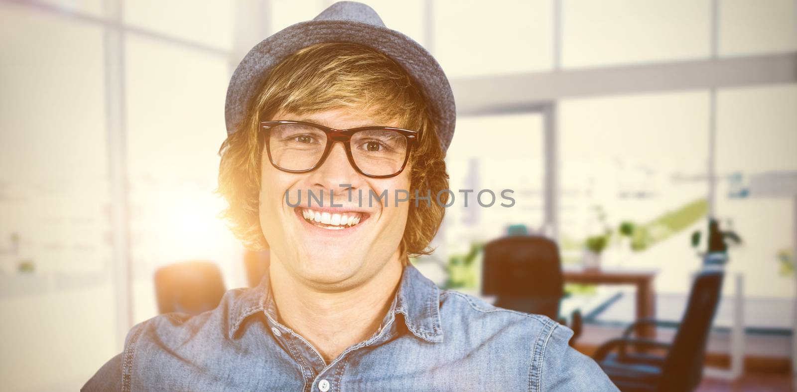 Smiling blond hipster staring at camera against board room