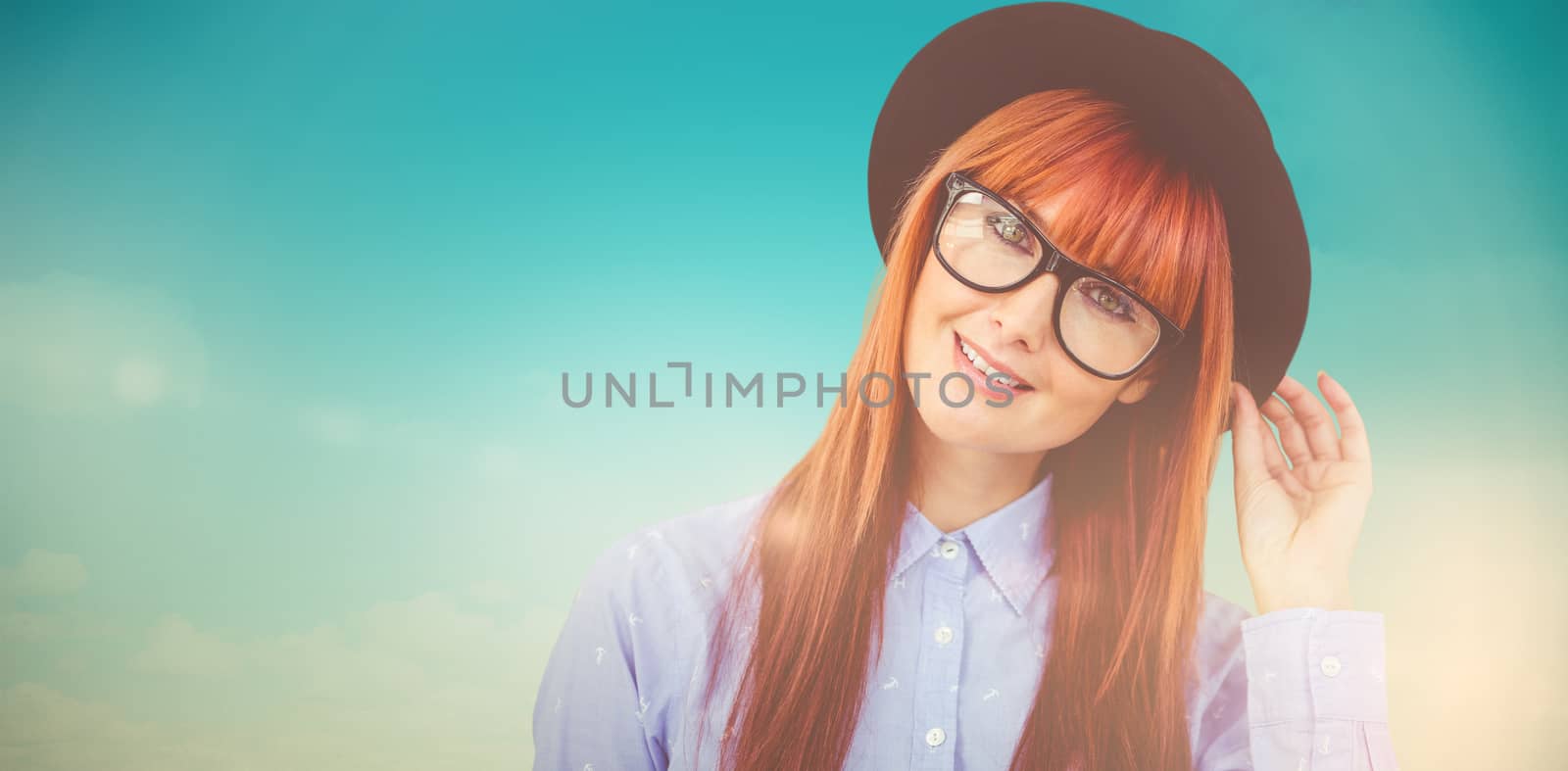Smiling hipster woman posing face to the camera against blue green background