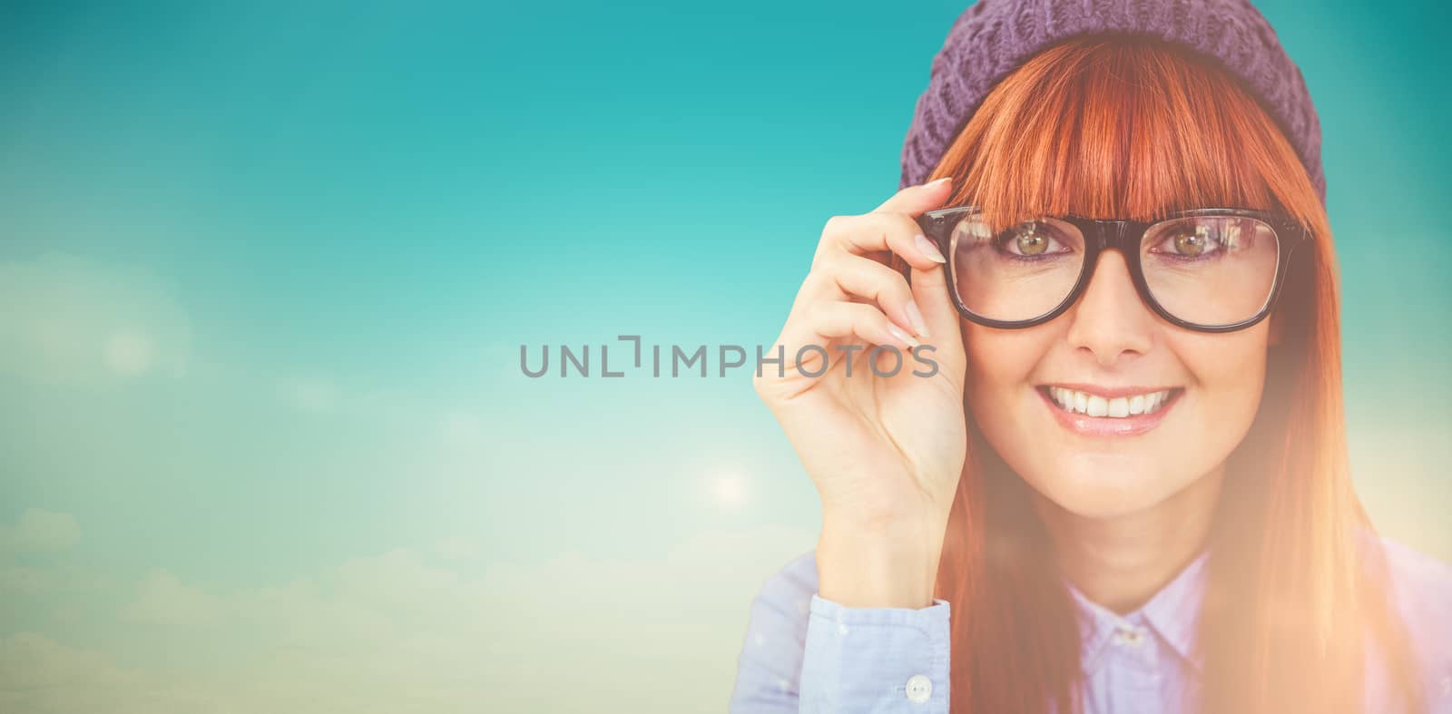 Smiling hipster woman looking at camera against blue green background