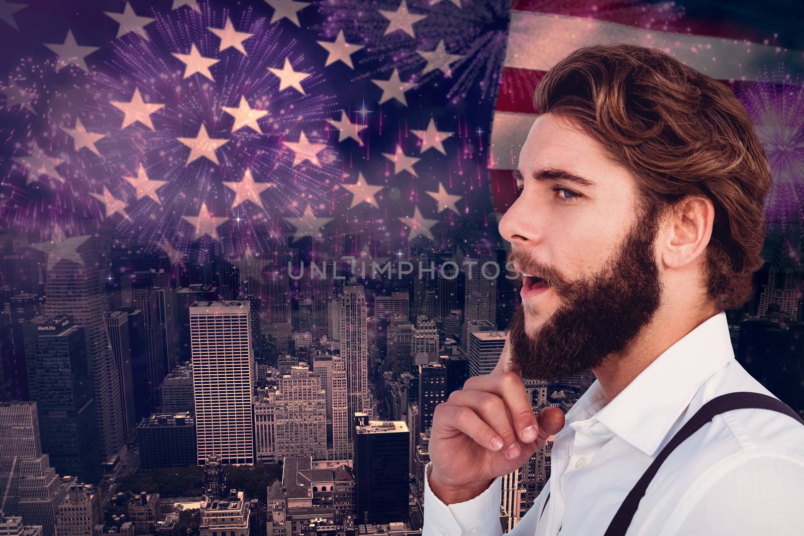 Thoughtful hipster with finger on chin against composite image of colourful fireworks exploding on black background