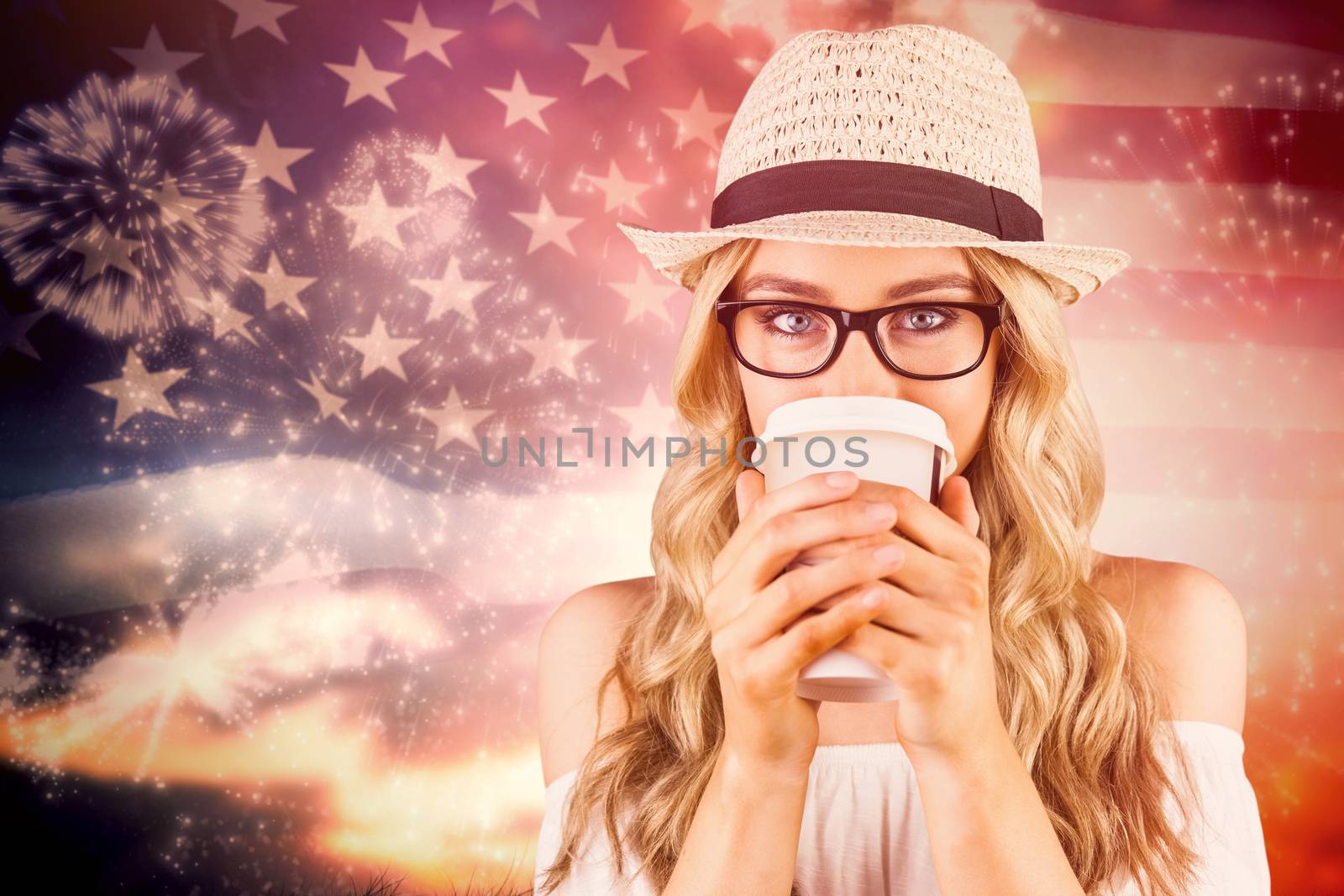 Gorgeous blonde hipster drinking out of take-away cup against composite image of white fireworks exploding on black background