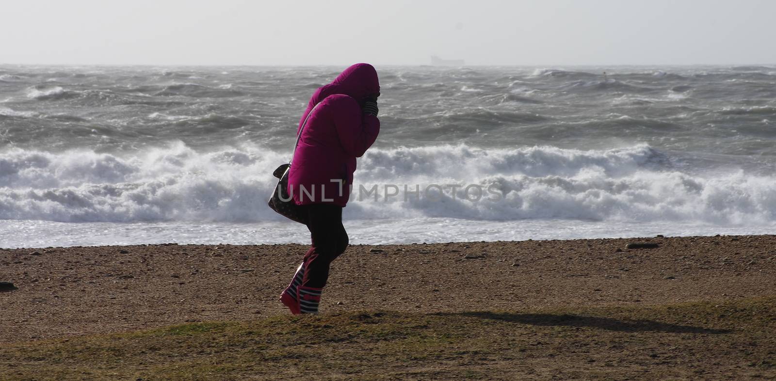 UK, Dorset: A woman faces into Storm Imogen's brutally high winds as waves crash on the south coastal beaches at Dorset, UK on February 8, 2016. With the UK on amber alert, gale-force winds and heavy rainfall have caused disruption to local train and ferry services. A 64-year-old inspector from the Royal Society for the Prevention of Cruelty to Animals reportedly went missing Sunday.