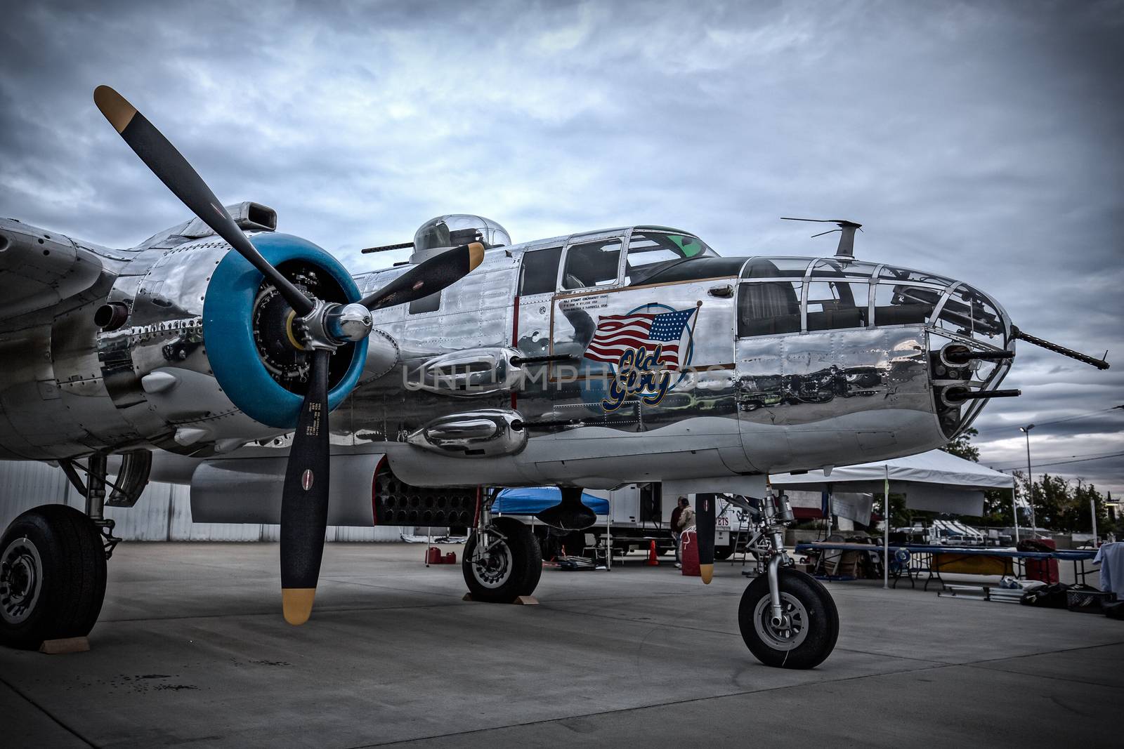 Redding, California, USA- September 28, 2014: A WWII era b-25 Mitchell bomber sits on display at an airshow in northern California and showcases it's 50 calibre machine guns and highly polished skin.