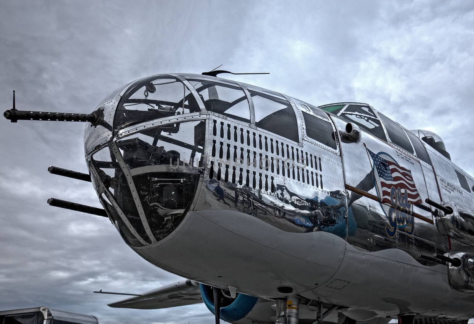 Redding, California, USA- September 28, 2014: A WWII era b-25 Mitchell bomber sits on display at an airshow in northern California and showcases it's 50 calibre machine guns and highly polished skin.