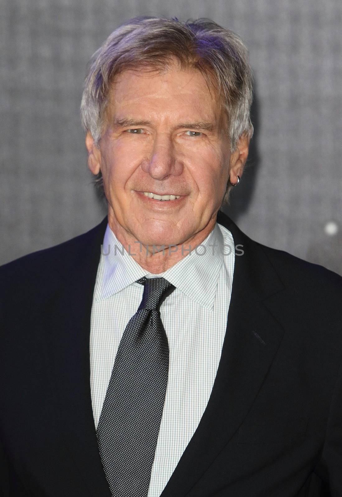 UNITED-KINGDOM, London : Star Wars actor Harrison Ford poses for photographers while Star Wars cast, crew and celebrities hit the red carpet for the last episode The Force Awakens European Premiere on December 16, 2015 in central London.   	