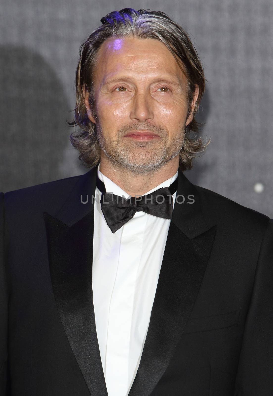 UNITED-KINGDOM, London : Danish famous actor Mads Dittmann Mikkelsen poses for photographers while Star Wars cast, crew and celebrities hit the red carpet for the last episode The Force Awakens European Premiere on December 16, 2015 in central London. The actor got cast in the Star Wars spinoff movie Star Wars: Rogue One.   	