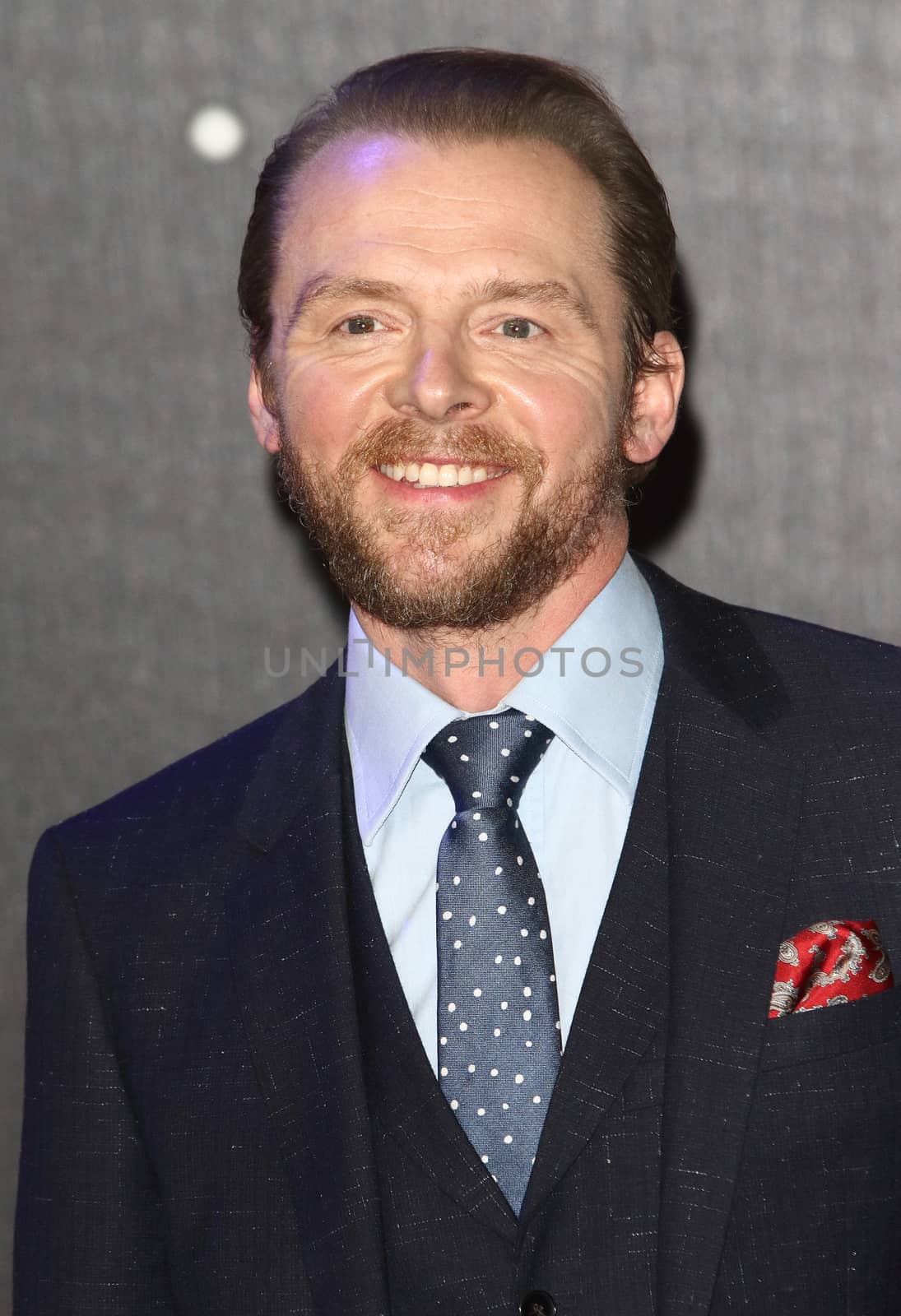 UNITED-KINGDOM, London : English actor Simon Pegg poses for photographers while Star Wars cast, crew and celebrities hit the red carpet for the last episode The Force Awakens European Premiere on December 16, 2015 in central London.   	
