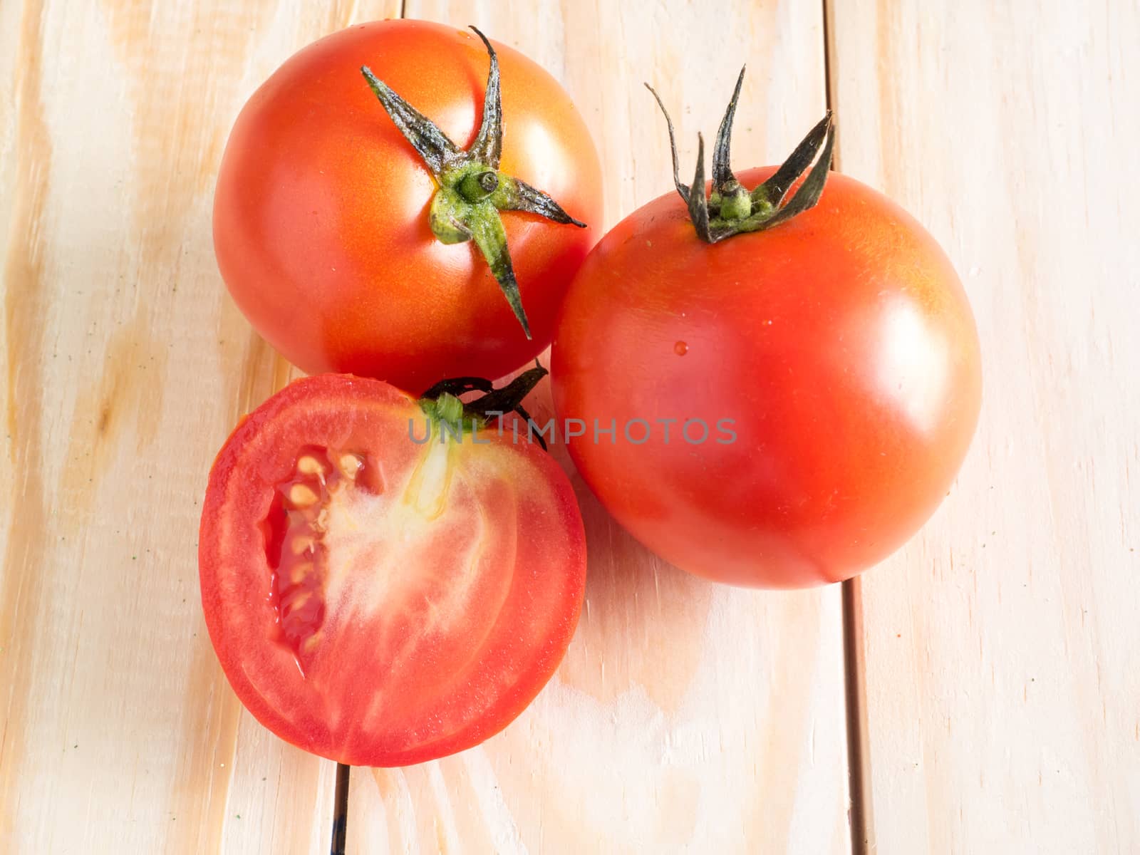 Fresh tomatoes on wood background