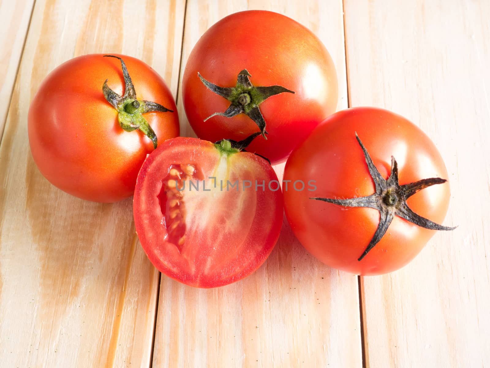 Fresh tomatoes on wood background