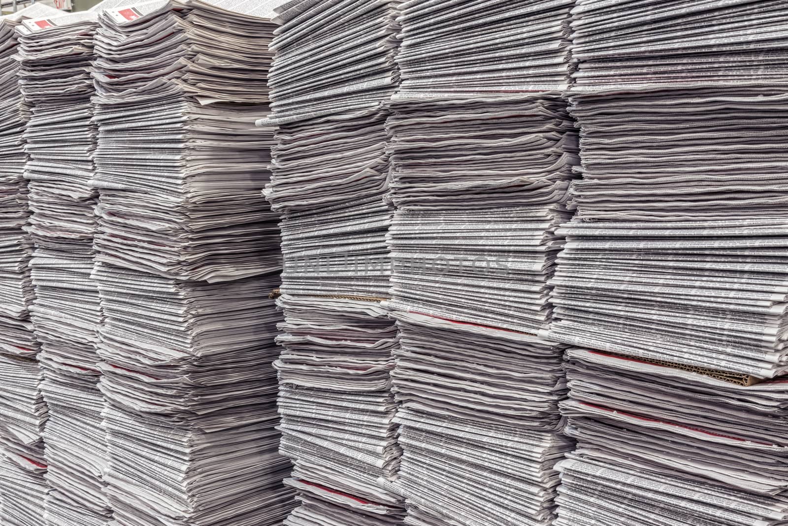 Close up shot of multiple newspaper stacks in a warehouse getting ready to be delivered