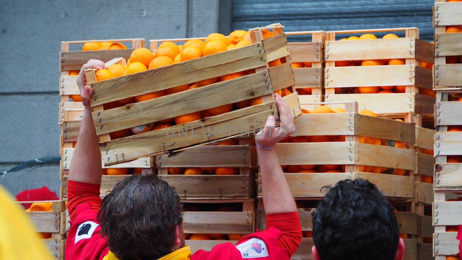 ITALY, Ivrea: People unload crates of oranges on February 7, 2016.An estimated 7,000 people turned out to pelt each other at the historic festival. 70 people were injured by the flying fruit.