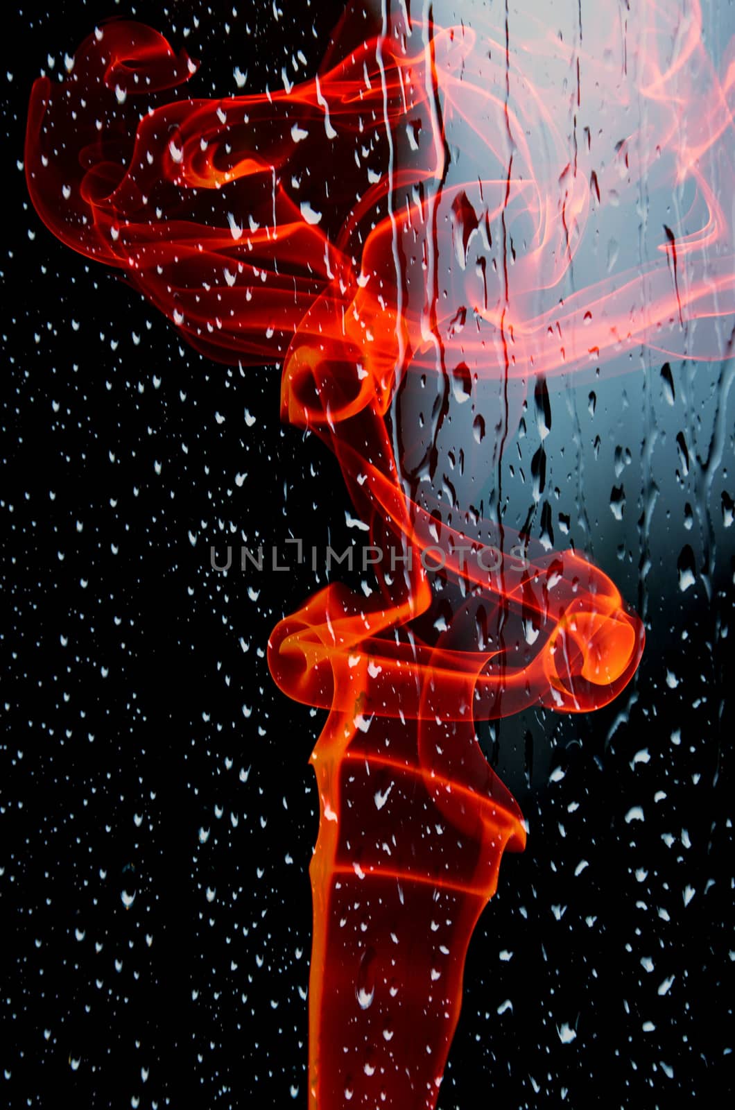 Smoke swirling on wet glass, black background
