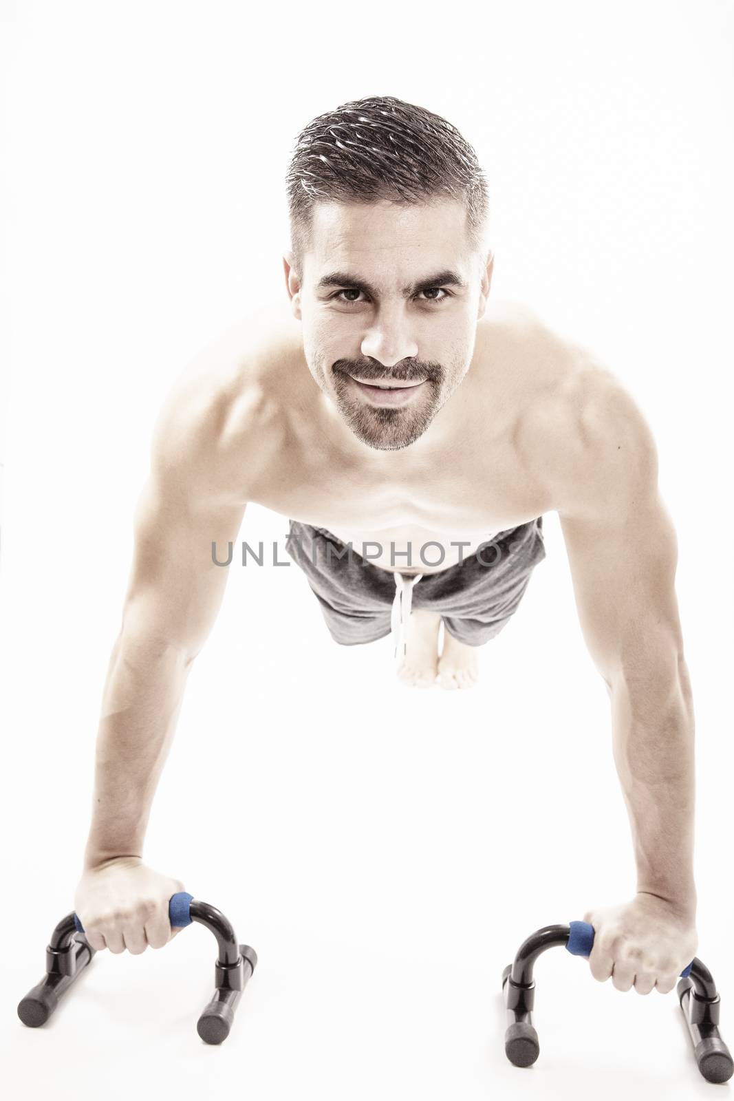 Strong model man doing push up exercises