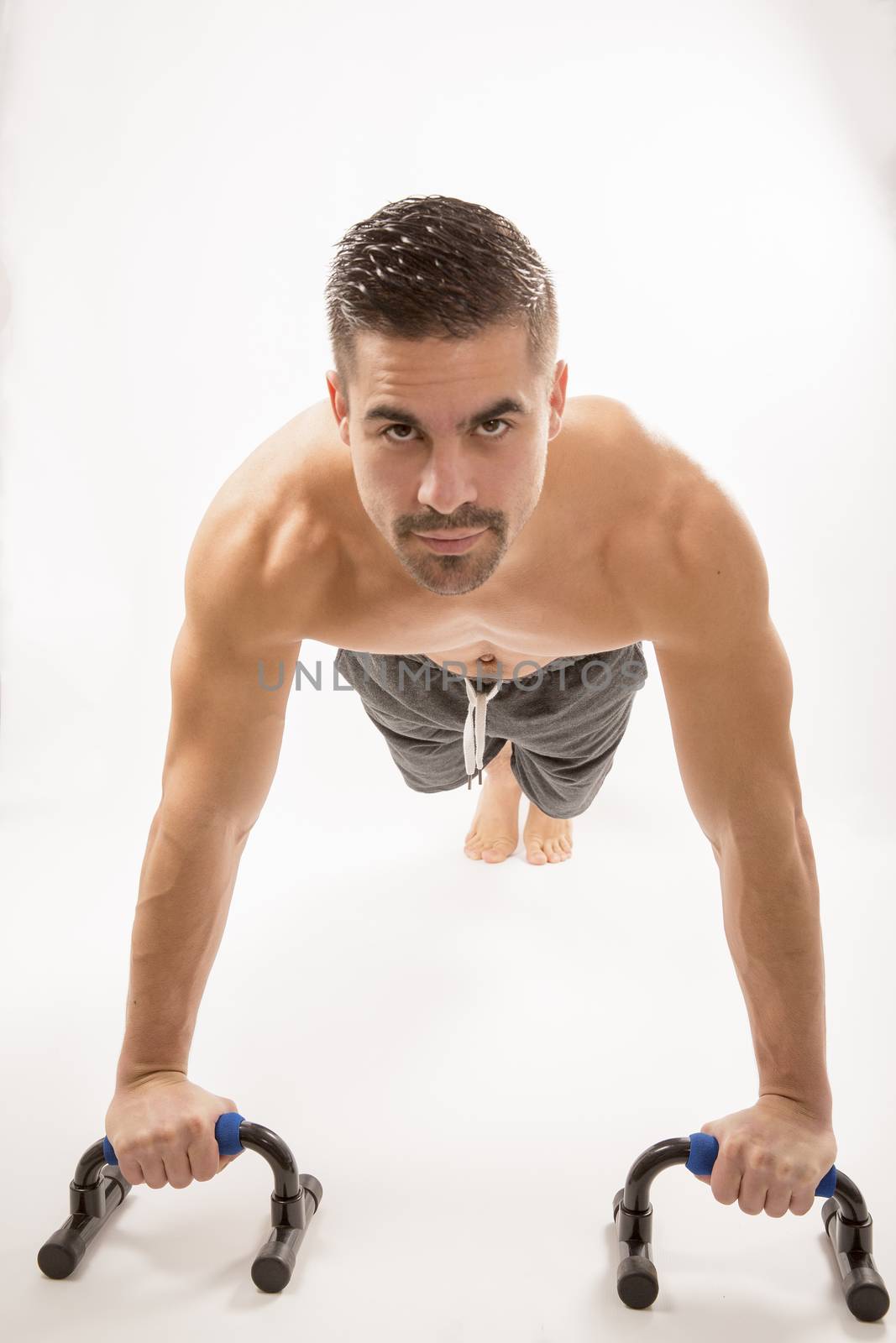 Strong model man doing push up exercises