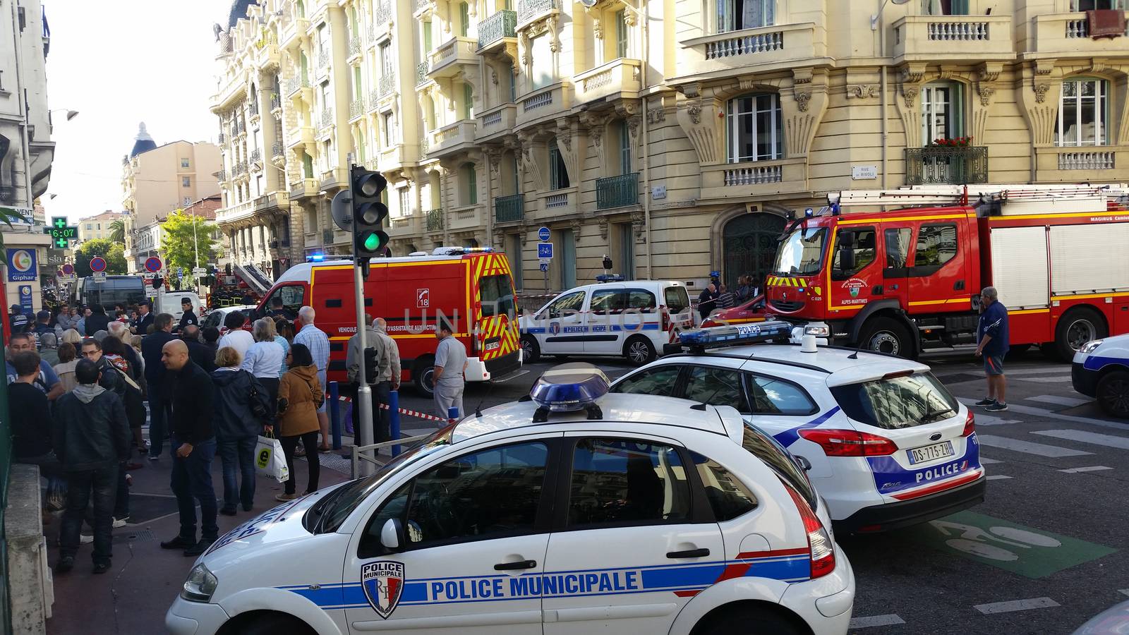 Nice, France - October 16 2015: French Police officers and Firefighters at Building Fire. Emergency Vehicles in the Streets of Nice (French Riviera) in France