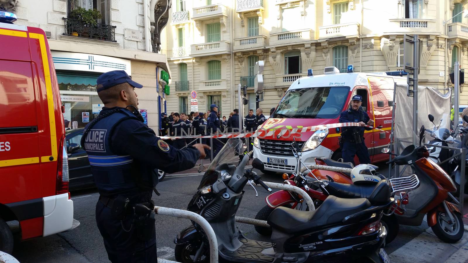 Nice, France - October 16 2015: French Police officers and Firefighters at Building Fire. Emergency Vehicles in the Streets of Nice (French Riviera) in France