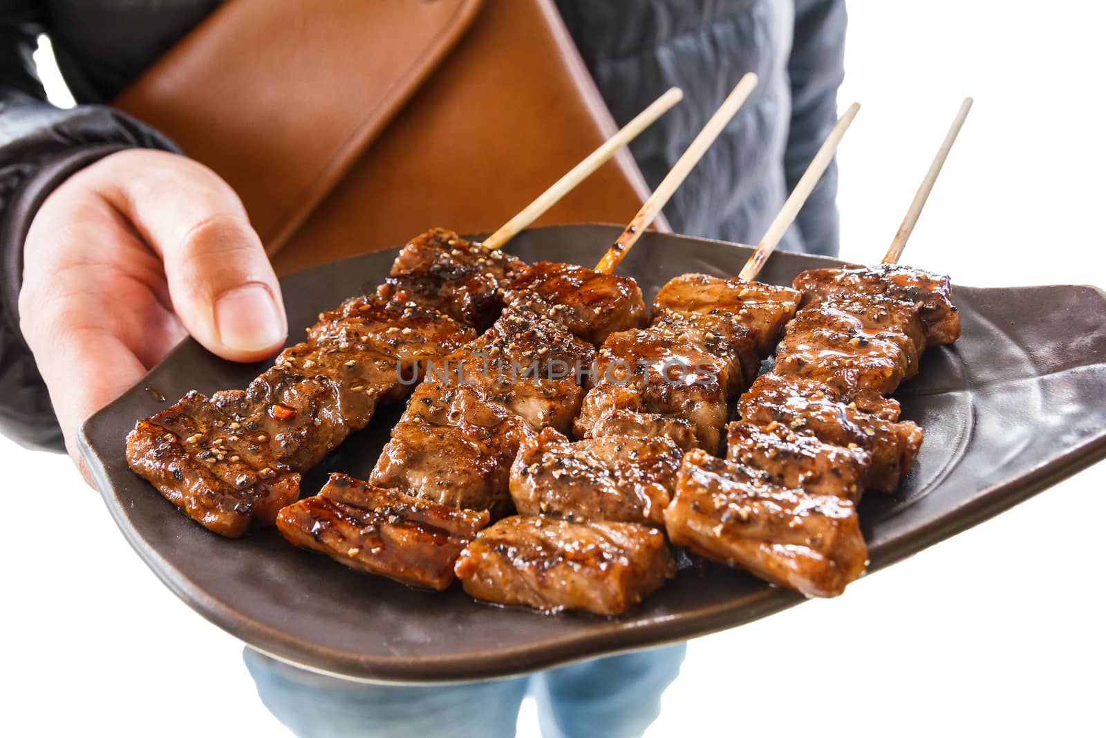 Isolated man holding beef bbq in a plate.With clipping path.