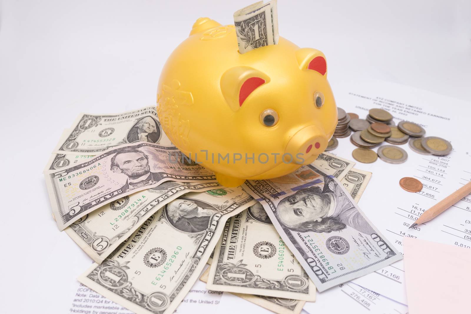 A piggy bank with money dollars and calculator  on financial report, savings