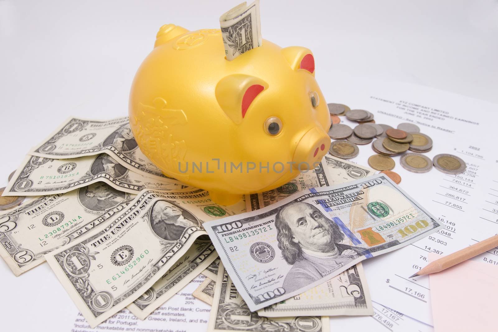 A piggy bank with money dollars and calculator  on financial report, savings