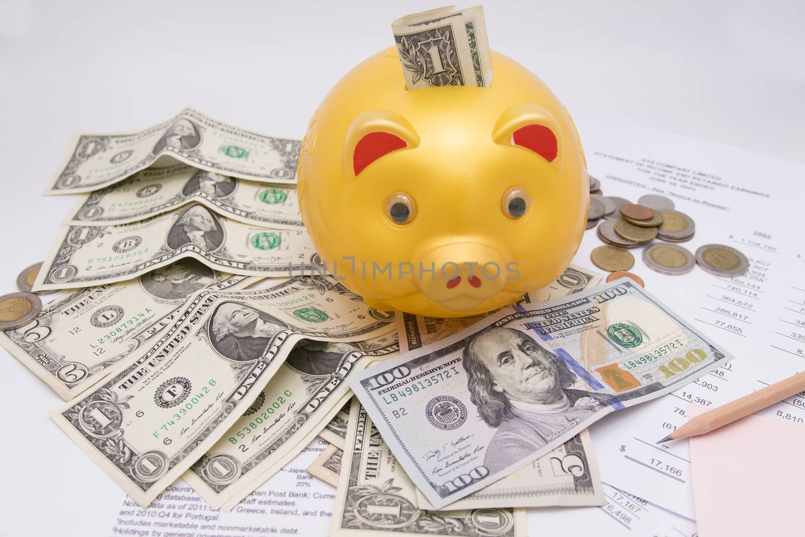 A piggy bank with money dollars and calculator  on financial report, savings