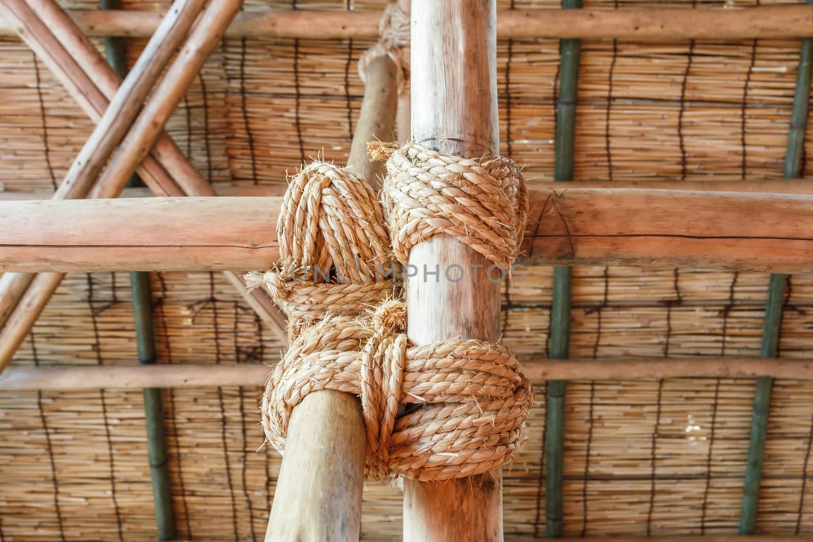 Rope tied wood pole together.