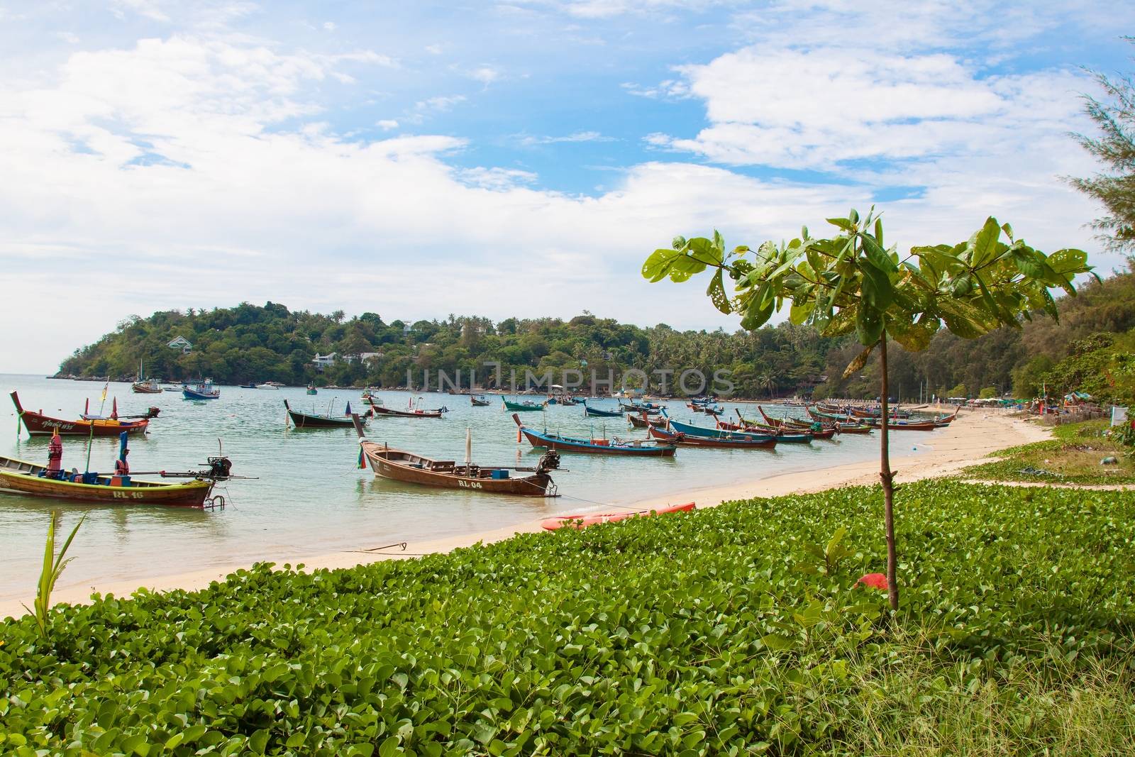 Phuket, Thailand - 20th december 2015: Beautiful landscape with Thai nature - blue sea with boats, grass and hills