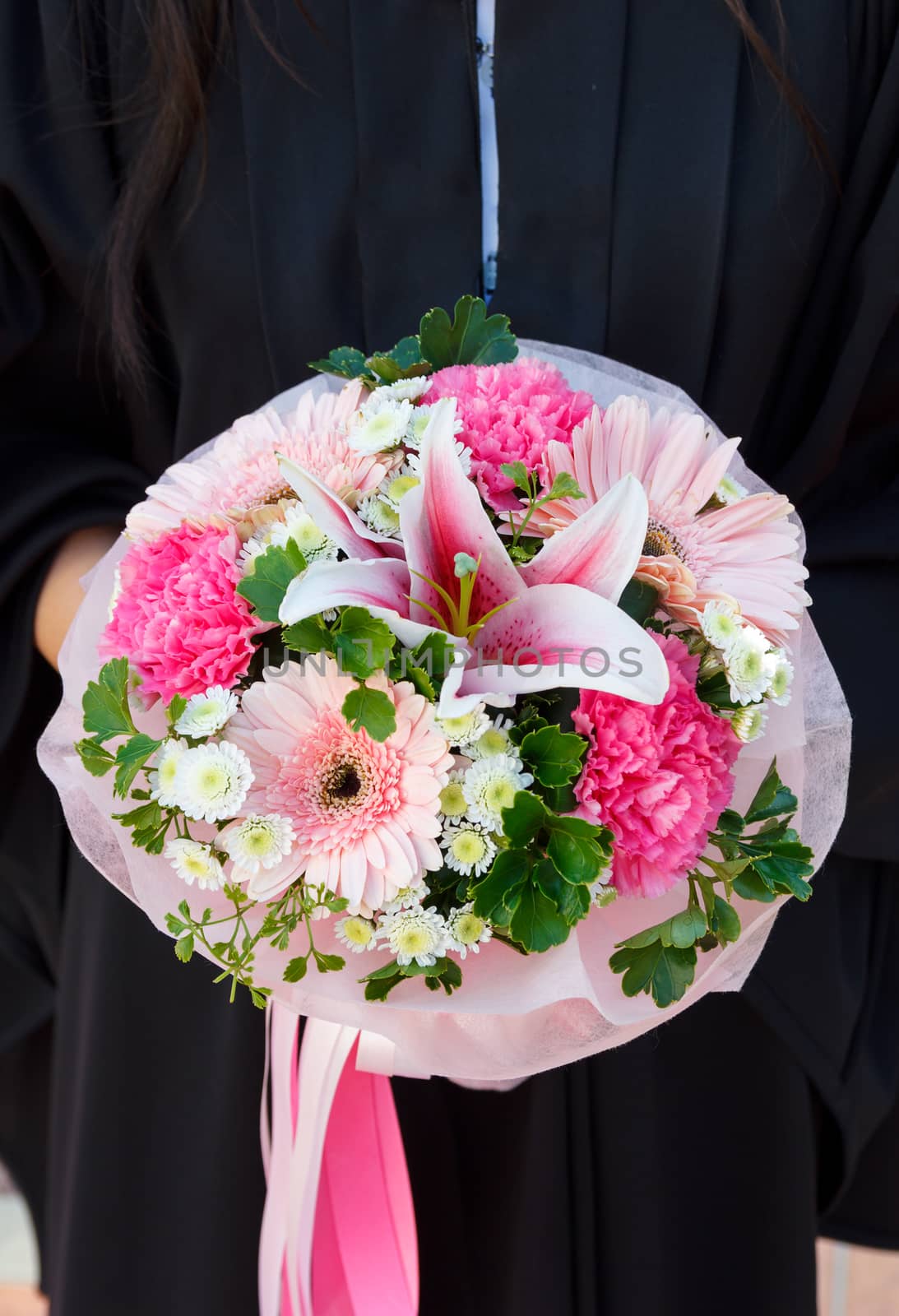 People hold bouquet of colorful flowers including Lily.