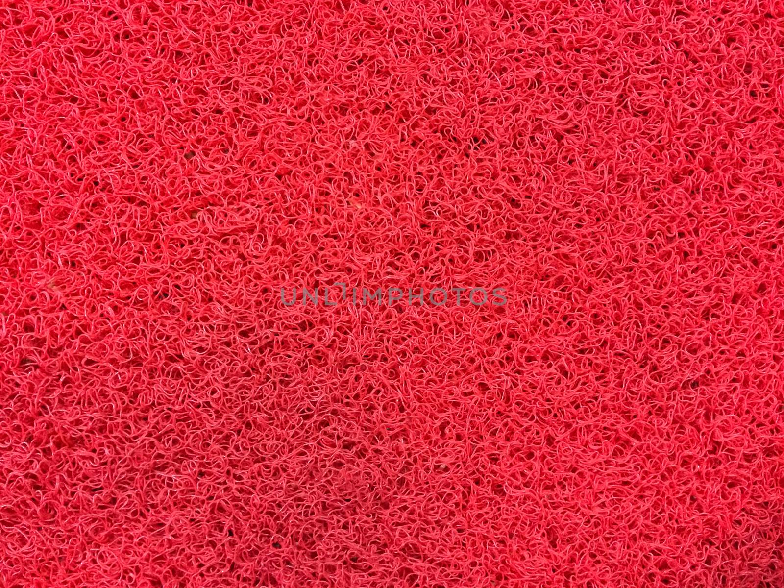 Texture of red fiber carpet.