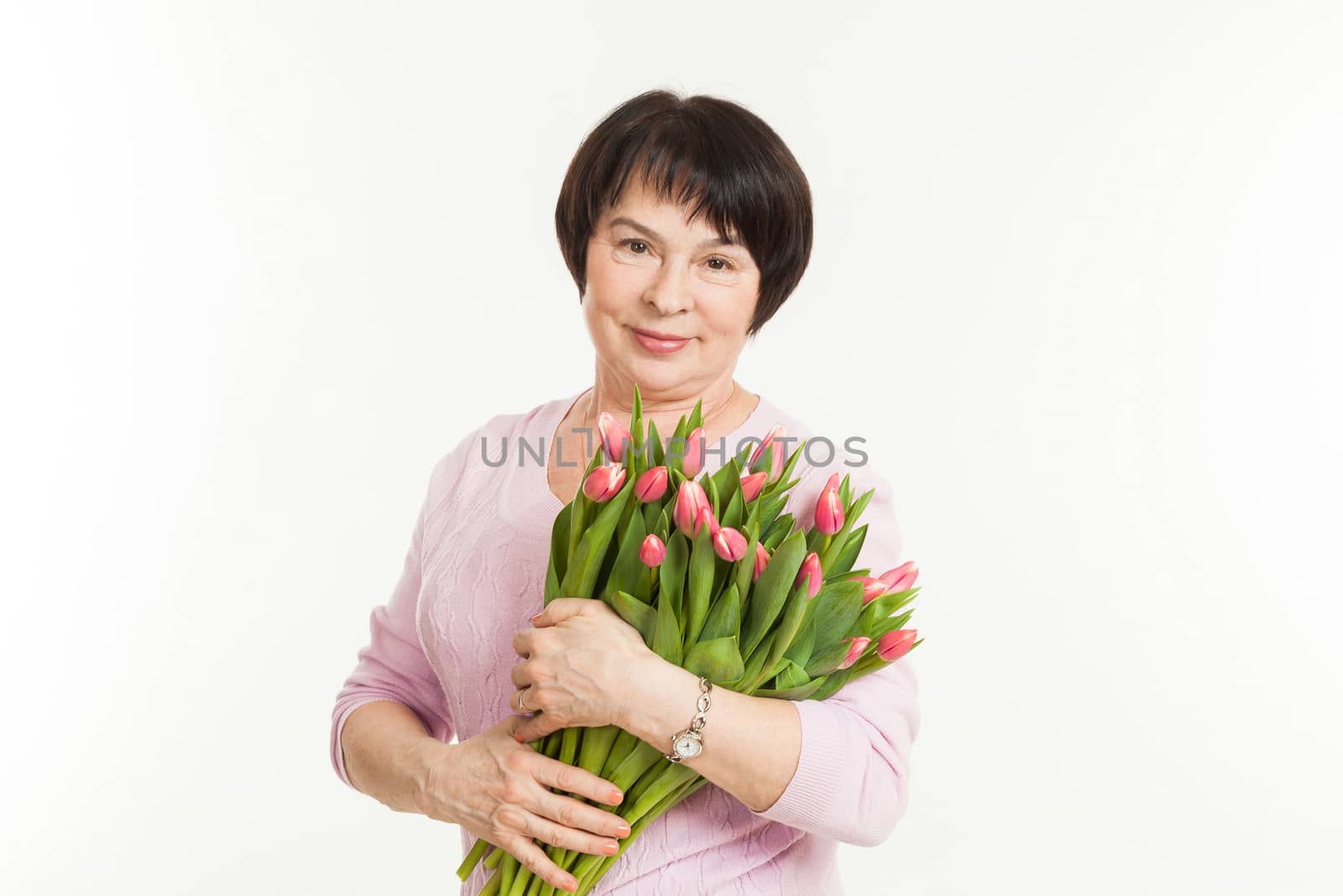 the beautiful mature woman with a bouquet of tulips