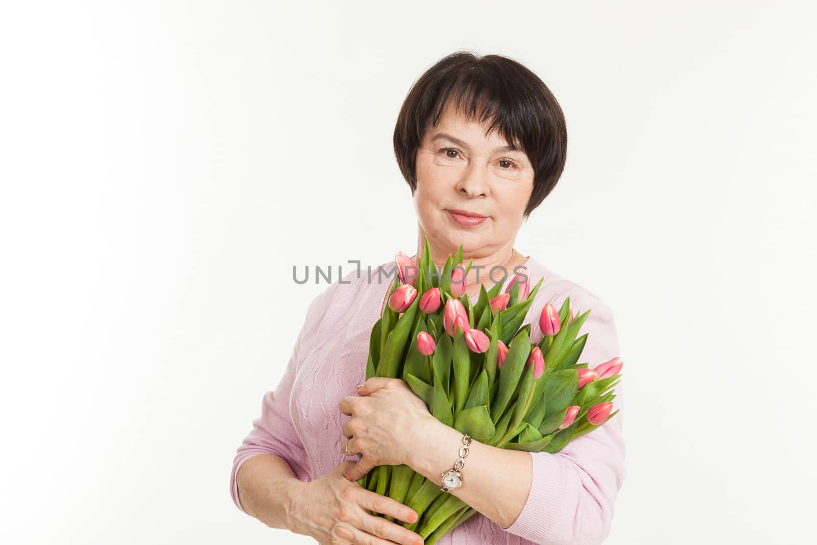 the beautiful mature woman with a bouquet of tulips