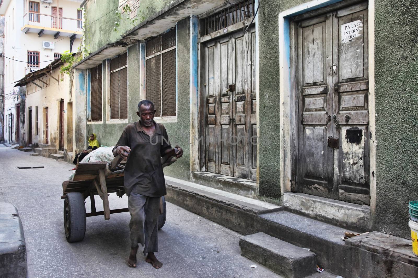 Stone Town (Zanzibar), Tanzania - January 1, 2016: unknown African man with a trolley in Stone Town, Zanzibar.