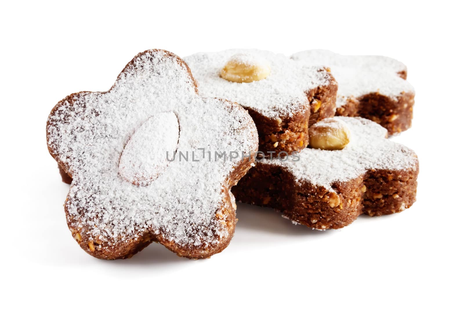 Chocolate cakes with nuts and powdered sugar on a white background